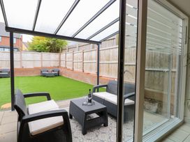 A garden with furniture and a glass roof at Manor Park View in Norwich