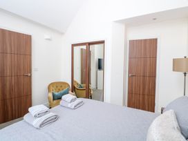 A bedroom with a bed and armchair at Manor Park View in Norwich