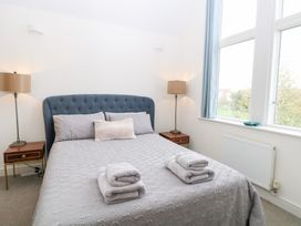 A bedroom with a bed and bedside table at Manor Park View Norwich