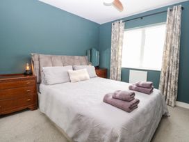 A bedroom with a bed and dresser at Manor Park View in Norwich