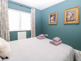 A bedroom with a bed and towels at Manor Park View in Norwich