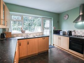 A kitchen with cabinets and appliances at Cromer Holiday Home in Cromer