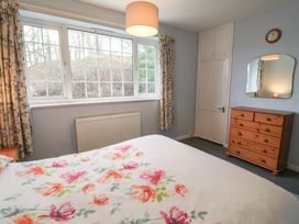 A bedroom with a bed and dresser at Cromer Holiday Home in Cromer