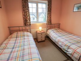 A bedroom with two single beds and a lamp at Cromer Holiday Home in Cromer