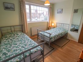 A bedroom with two beds and a window at Cromer Holiday Home in Cromer
