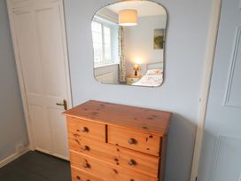 A bedroom with a dresser and mirror at Cromer Holiday Home in Cromer