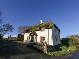 A house with a thatched roof and garden at Honeysuckle Cottage Smallridge Nr. Axminster
