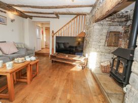 A living room with a sofa and television at Honeysuckle Cottage Smallridge Nr. Axminster