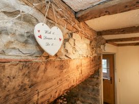 A heart sign and stone wall in a hallway at Honeysuckle Cottage Smallridge Nr. Axminster