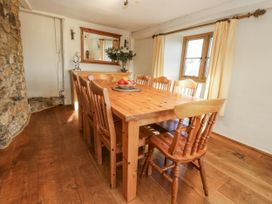 A dining room with a table and chairs at Honeysuckle Cottage Smallridge Nr. Axminster