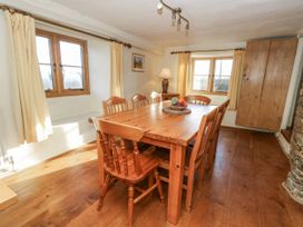 A dining room with a table and chairs at Honeysuckle Cottage in Smallridge Nr. Axminster