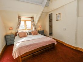 A bedroom with a bed and two nightstands at Honeysuckle Cottage in Smallridge Nr. Axminster