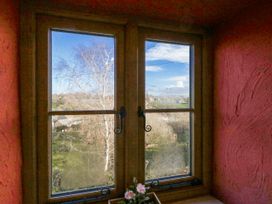 A window with a view of trees and fields at Honeysuckle Cottage Smallridge Nr. Axminster