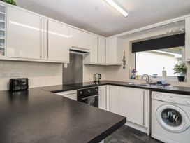 A kitchen with a sink and stove at Willow Lodge Rosecraddoc Lodge near Liskeard