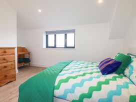 A bedroom with a bed and a dresser at Barn 5