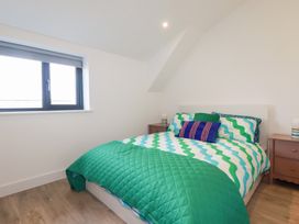 A bedroom with a bed and bedside tables at Barn 5