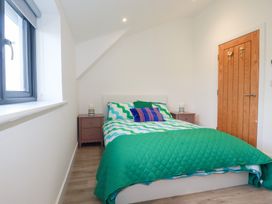 A bedroom with a bed and nightstand at Barn 5