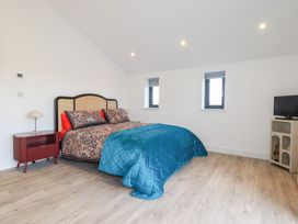 A bedroom with a bed and windows at Barn 5