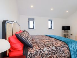 A bedroom with a bed and tv at Barn 5