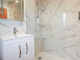 A bathroom with a shower and sink at Barn 5