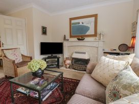 A living room with a fireplace and television at Apple Byrd in Kendal