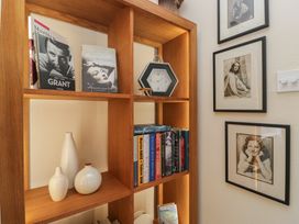 A bookshelf with books and decorative items at Apple Byrd in Kendal