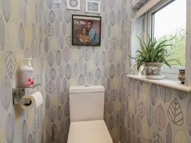 A bathroom with a toilet and potted plant at Apple Byrd in Kendal