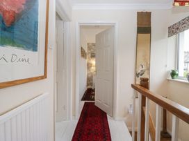 A hallway with a door and a rug at Apple Byrd in Kendal