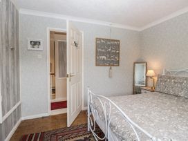 A bedroom with a bed and lamp at Apple Byrd in Kendal