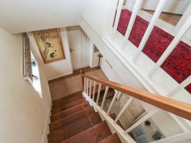 A staircase with a rug and artwork at Apple Byrd in Kendal