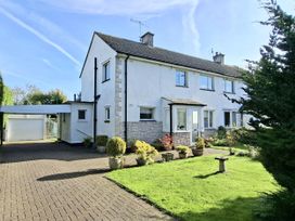 A house with a carport and garden at Apple Byrd in Kendal