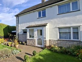 A house with a front porch and garden at Apple Byrd in Kendal