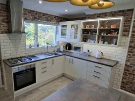 A kitchen with appliances and cabinetry at Apple Byrd in Kendal