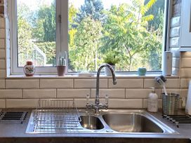 A sink with a faucet and dish rack near a window at Apple Byrd in Kendal
