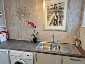 A kitchen with a sink and washing machine at Apple Byrd in Kendal