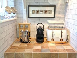 A kitchen countertop with a kettle, coffee machine, and toaster at Apple Byrd in Kendal