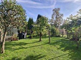 A garden with trees and grass at Apple Byrd in Kendal