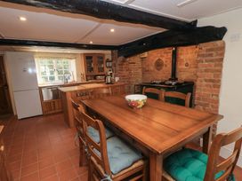 A kitchen with a table and chairs at Plush Cottage in Dorchester