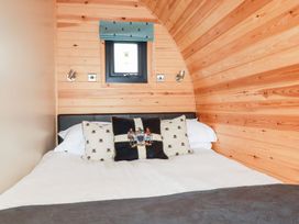 A bedroom with a bed and window at Barry in Polgooth