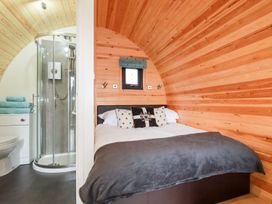 A bedroom with a double bed and shower at Barry in Polgooth