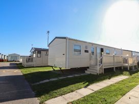 A mobile home with a porch on a pathway at The Pad in 
