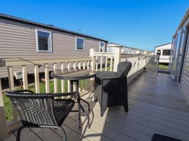 Outdoor patio with chairs and a table at The Pad in 