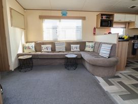 A living room with a sofa and coffee tables at The Pad