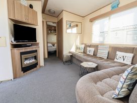 A living room with a sofa and television at The Pad in 