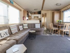 A living room with a sofa and dining table at The Pad