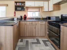 A kitchen with appliances and cabinetry at The Pad