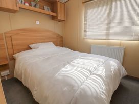 A bedroom with a bed and a shelf at The Pad in 