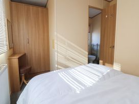 A bedroom with a bed, wardrobe, and mirror at The Pad in 