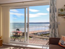 A living room with a view of the ocean from a balcony at Beachside