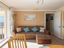 A living room with a sofa and door at Beachside